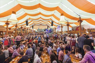 People in a beer tent at the Cannstatter Volksfest