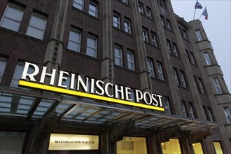 Illuminated logo of the daily newspaper Rheinische Post on the former editorial building Martin-Luther-Platz