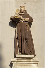 Monk figure with book and child at the seminary in Hildesheim