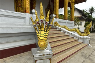 Five-headed mythological Naga serpent decorates the end of a stair railing