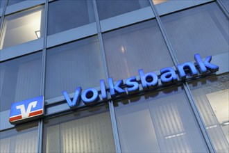 Illuminated logo of the Volksbank Duesseldorf Neuss eG at the Koenigsallee branch