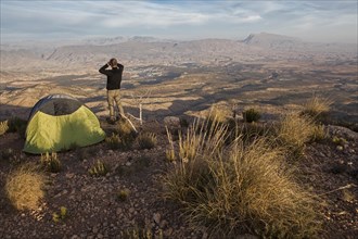 Young man contemplates the landscape of the Jbel Bou Naceur mountain in the province of Sefru