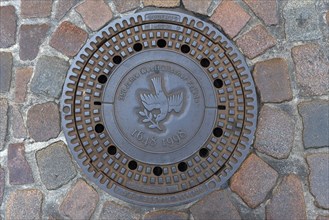 Manhole cover with the symbol of a peace dove on the occasion of the 350th anniversary of the Peace of Westphalia