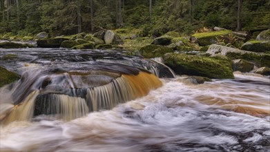 Waterfall at the Vydra with huge boulders in the riverbed