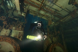 Tech diver with special equipment in shipwreck