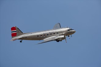 Douglas DC-3 Dakota aircraft in flight in Norway markings