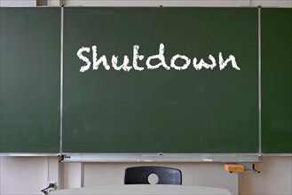 Blackboard with inscription SHUTDOWN