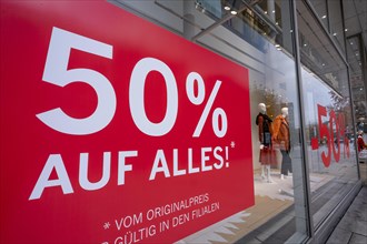 Large stickers with 50% discount offer on the window of the closed department store Appelrath Cuepper on the Zeil