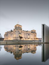 Reichstag with waving German flag at the Spree