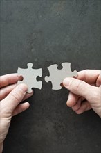 Two puzzle pieces in your hands