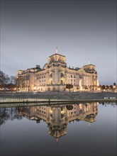 Reichstag with waving German flag at the Spree