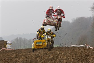 Motorcycle team in the air during a motocross race