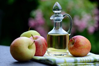 Carafe with apple vinegar and apples