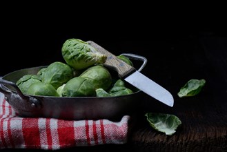 Brussels sprouts in bowl with kitchen knife