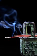 Burning incense sticks on incense burner