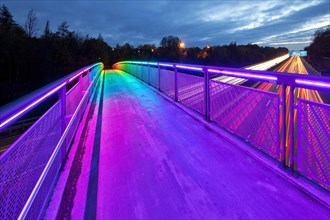 Rainbow bridge over the motorway A 40 in the evening