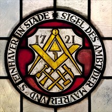 Seal of the guild of masons and stonemasons from 1721 as stained glass window in the town hall