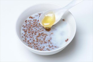 Bowl of swollen flax seed and spoonful of honey