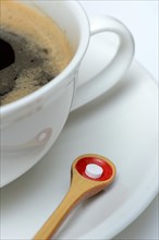 Sweetener tablet and coffee cup