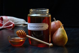 Pear syrup in glass jar and bowl