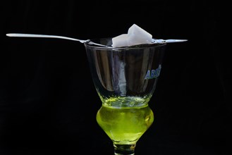 Glass of absinthe with absinthe spoon and sugar cubes