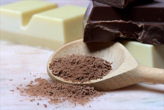 Grated chocolate blocks in cooking spoon