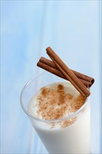 Cinnamon milk in glass and cinnamon sticks