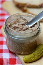 Liver sausage in glass with knife