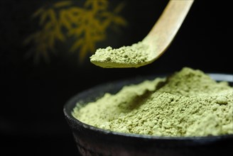 Japanese Matcha tea in bowl with bamboo spoon
