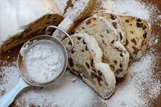 Christmas stollen and sieve with icing sugar