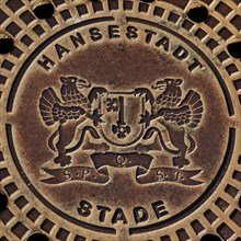 Coat of arms of the Hanseatic City of Stade on a manhole cover