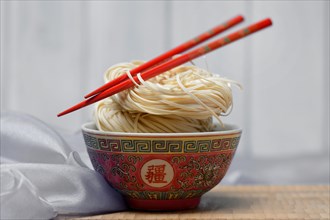 Chinese Yangchun noodles in bowl with chopsticks