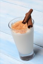 Cinnamon milk in glass and cinnamon sticks