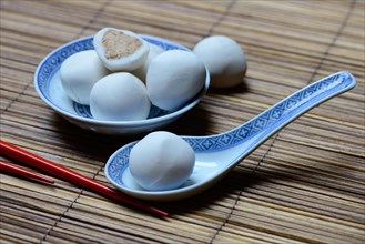 Glutinous rice balls with peanut filling in bowl and spoon