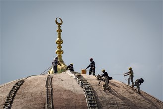 Worker on the dome of a mosque