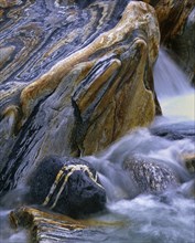 Stones with rock veins and running water