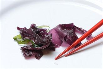 Red algae with sea salt and chopsticks
