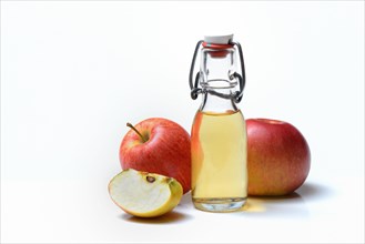 Bottle with apple vinegar and apples