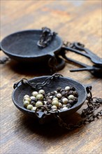 Peppercorns in weighing pan