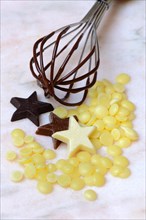Cocoa butter and chocolate stars with whisk