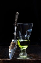 Glass of absinthe with absinthe spoon