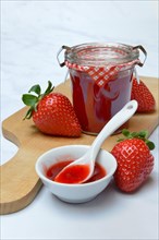 Strawberry jam in bowl and glass