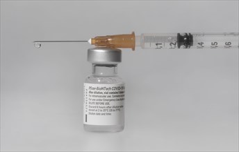Vaccine vial against Covid 19 and syringe with drops