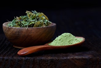 Moringa leaves in bowl and moringa powder in spoon