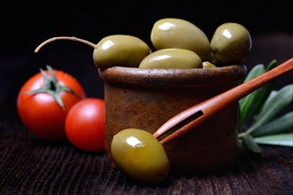 Green olives in clay dish