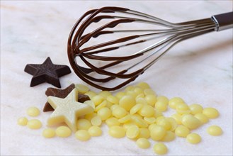 Cocoa butter and chocolate stars with whisk