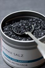 Black Hawaiian salt with spoon in tin