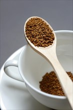Instant coffee with wooden spoon and coffee cup