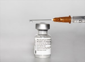 Vaccine vial against Covid 19 and syringe with drops