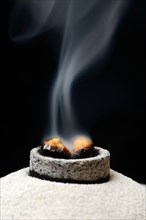 Incense is burned with the help of smoking coal